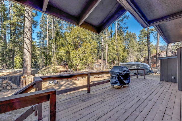 wooden terrace with a grill