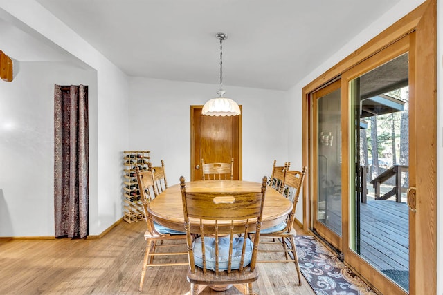 dining area with wood-type flooring and french doors