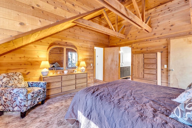 carpeted bedroom with beamed ceiling, high vaulted ceiling, ensuite bath, and wood ceiling