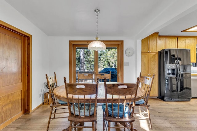 dining space with light hardwood / wood-style floors