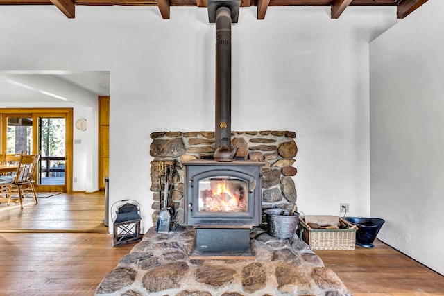 room details featuring hardwood / wood-style floors and a wood stove