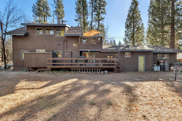 rear view of house with a balcony and a deck