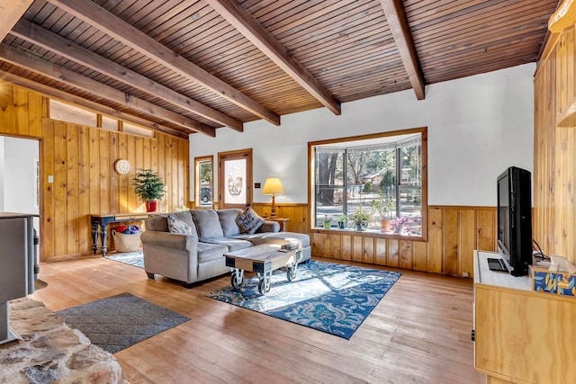 living room featuring lofted ceiling with beams, wooden ceiling, and light wood-type flooring