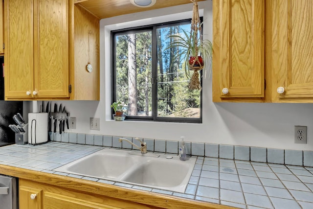 kitchen featuring tile counters and sink