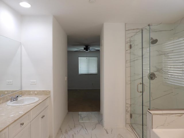 bathroom with ceiling fan, a shower with door, and vanity