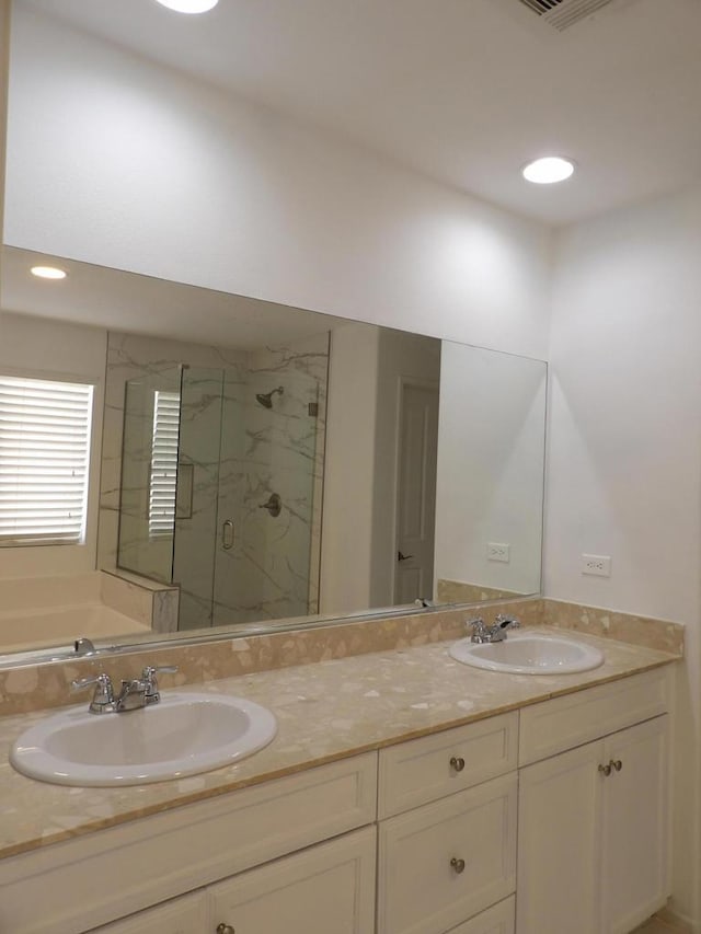 bathroom featuring plus walk in shower and vanity