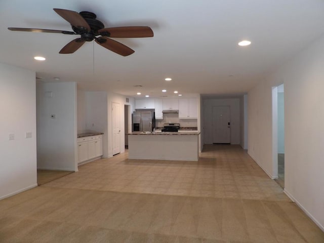 unfurnished living room with light carpet and ceiling fan