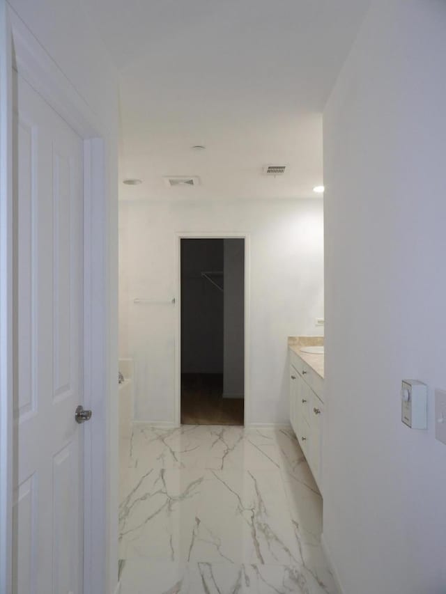 bathroom featuring a tub and vanity