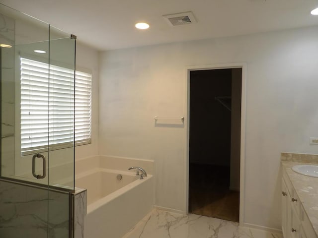 bathroom with vanity and independent shower and bath