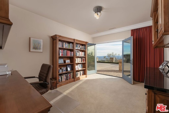 carpeted office with french doors and crown molding