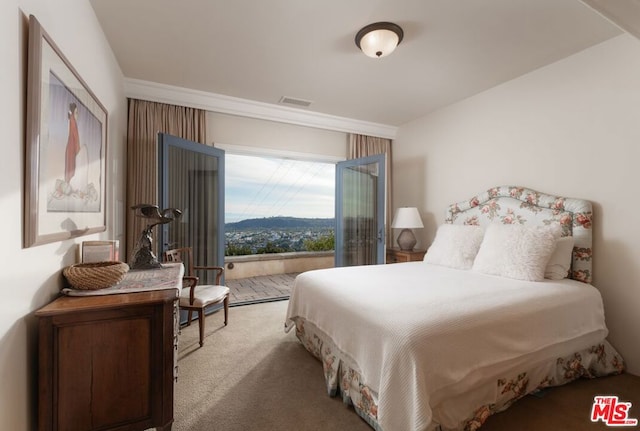 bedroom featuring a mountain view and light carpet