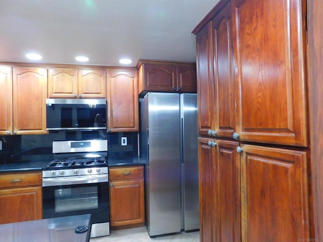 kitchen with light tile patterned floors and appliances with stainless steel finishes