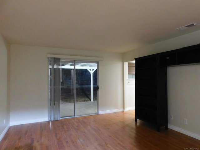 spare room featuring hardwood / wood-style floors