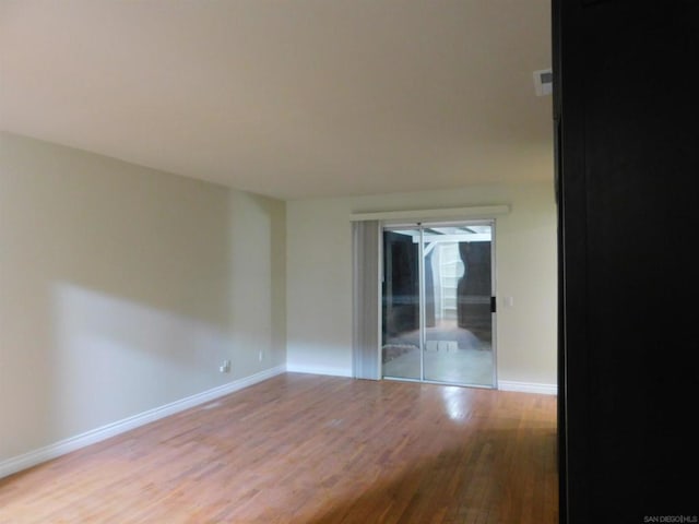 unfurnished room with light wood-type flooring