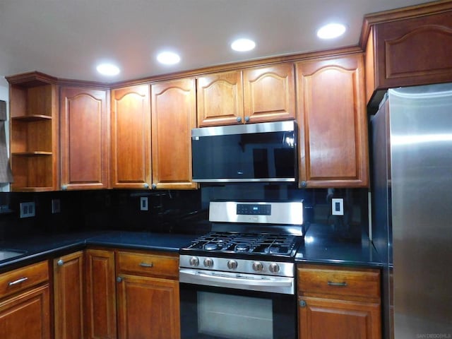 kitchen with appliances with stainless steel finishes and tasteful backsplash