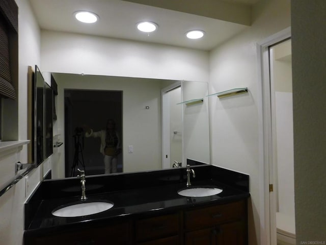 bathroom featuring vanity and toilet