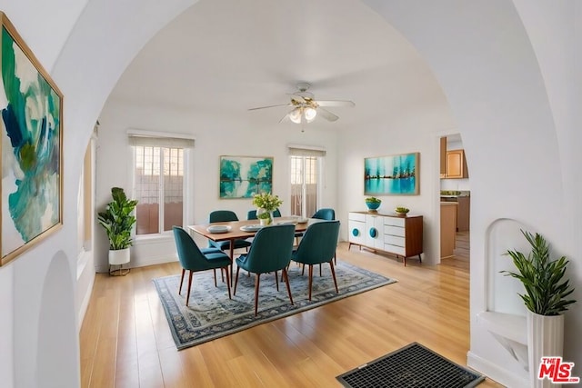 dining room with light wood-type flooring, plenty of natural light, and ceiling fan