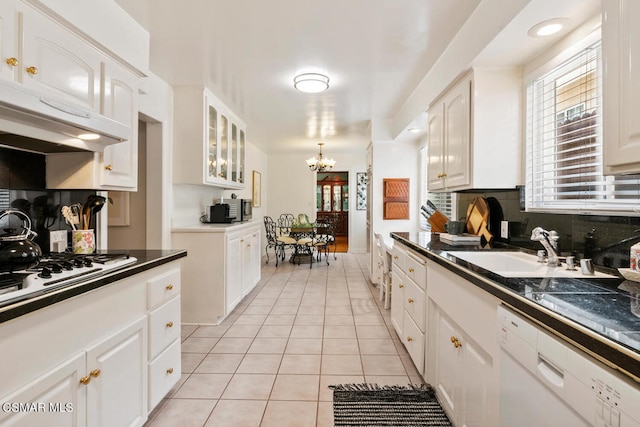 kitchen with white cabinets, a healthy amount of sunlight, white appliances, and sink