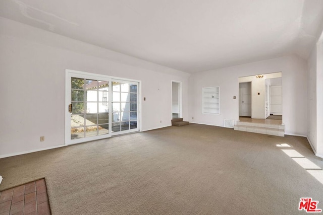 unfurnished living room with built in shelves and carpet floors