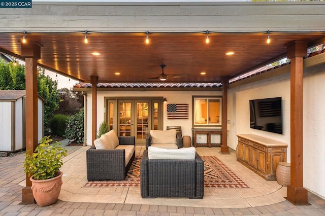 view of patio / terrace with an outdoor living space, french doors, ceiling fan, and a storage unit