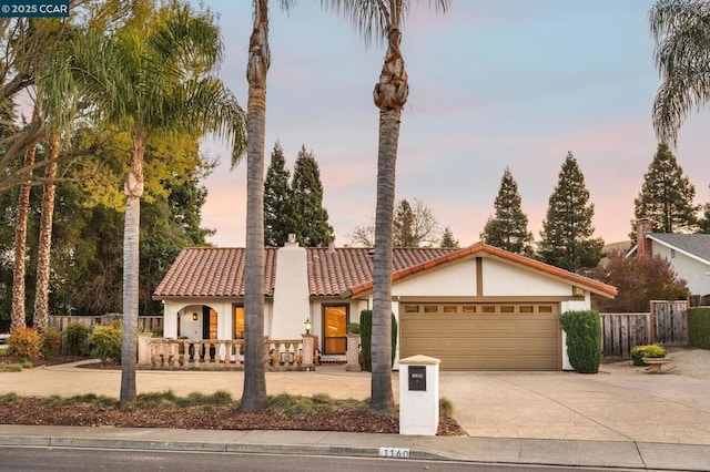 mediterranean / spanish-style house with a garage