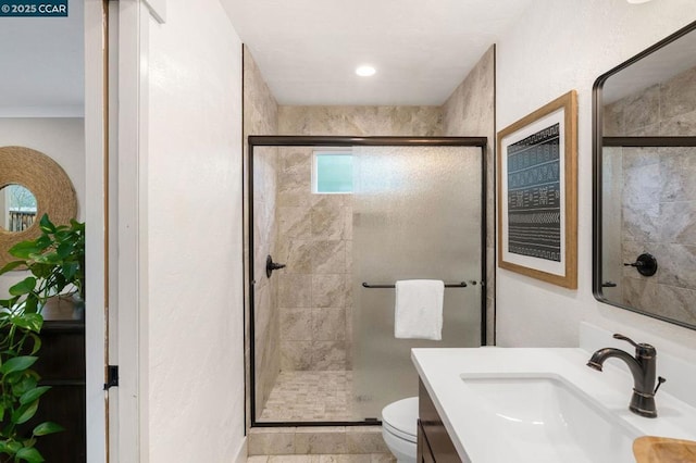 bathroom with vanity, toilet, and walk in shower