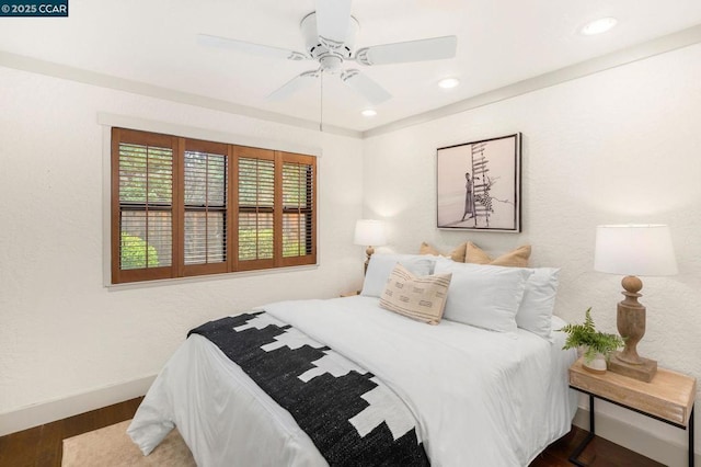 bedroom featuring ceiling fan and dark hardwood / wood-style floors