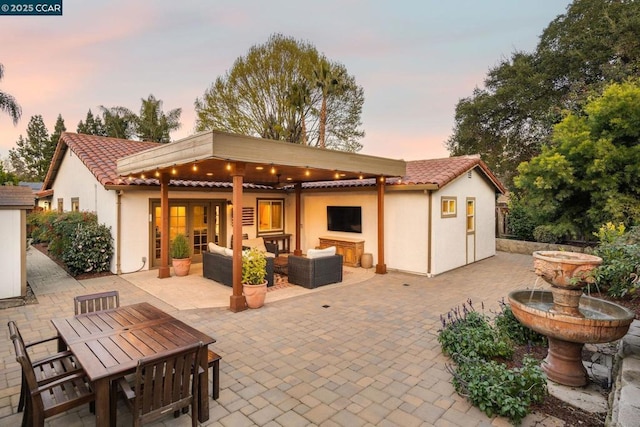 back of property featuring outdoor lounge area and a patio area