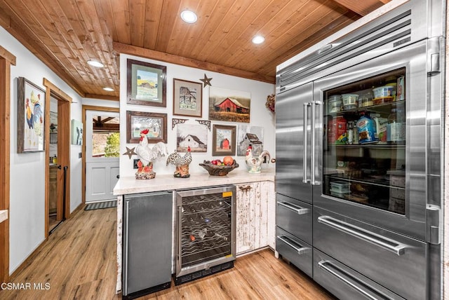 kitchen featuring wood ceiling, beverage cooler, stainless steel built in refrigerator, and light wood-type flooring