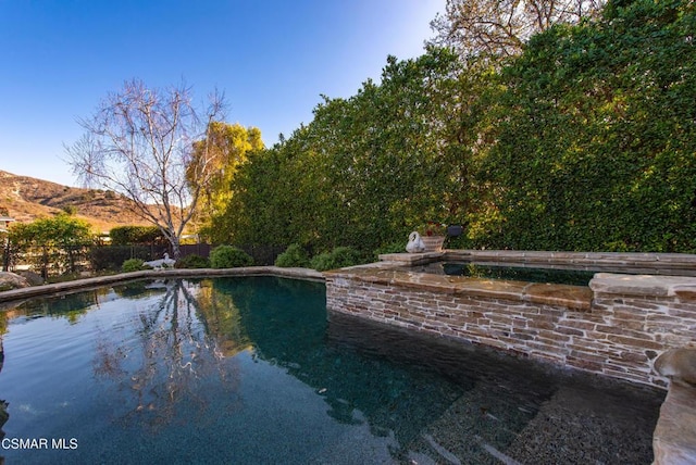 view of swimming pool with a mountain view