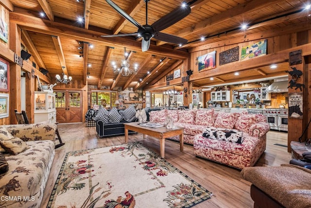 living room featuring lofted ceiling with beams, ceiling fan with notable chandelier, wooden walls, light hardwood / wood-style flooring, and wood ceiling