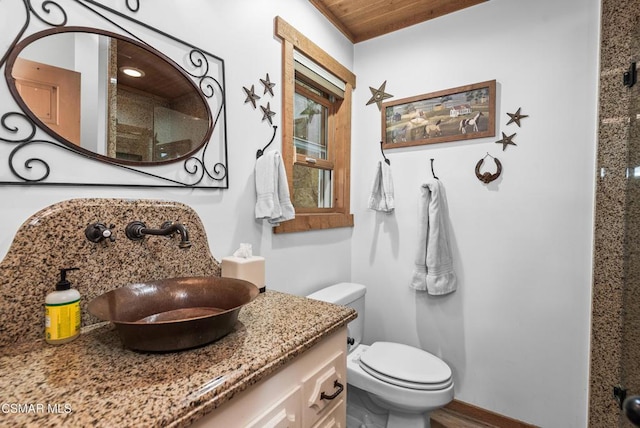 bathroom featuring vanity, toilet, and wood ceiling