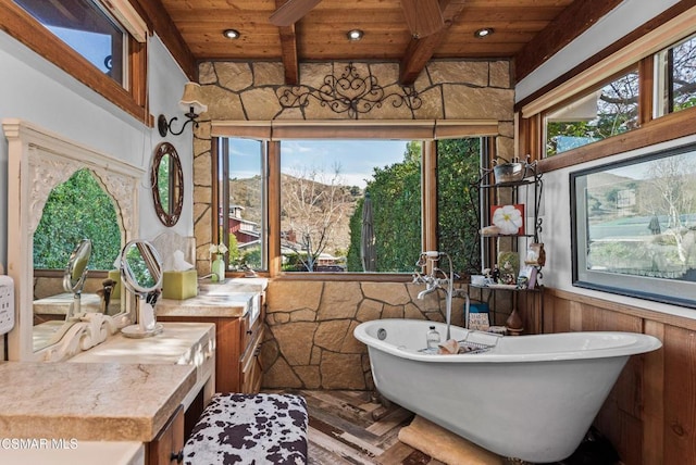 bathroom with a bathing tub, beam ceiling, and wooden ceiling