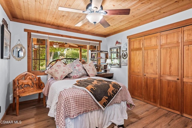 bedroom with a closet, ceiling fan, light hardwood / wood-style flooring, and wooden ceiling