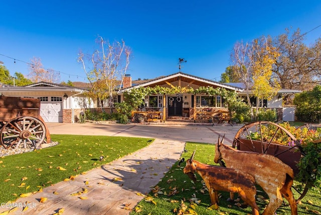 back of house with a yard and a garage