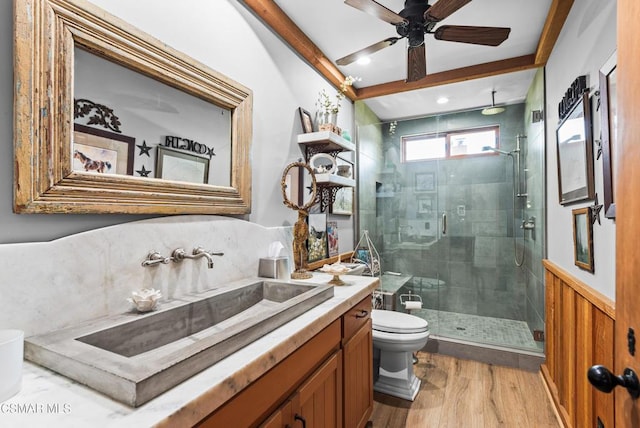 bathroom featuring vanity, a shower with door, ceiling fan, hardwood / wood-style floors, and toilet