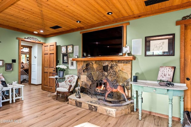 living room featuring a stone fireplace, wooden ceiling, and light hardwood / wood-style floors