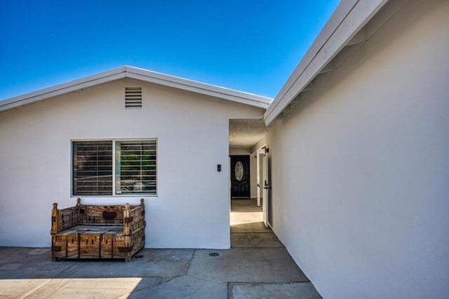 entrance to property featuring a patio