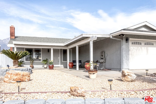 ranch-style house featuring a garage