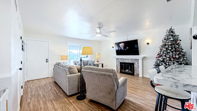 living room with ceiling fan and hardwood / wood-style floors