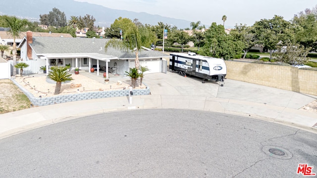 view of front of property with a mountain view and a garage