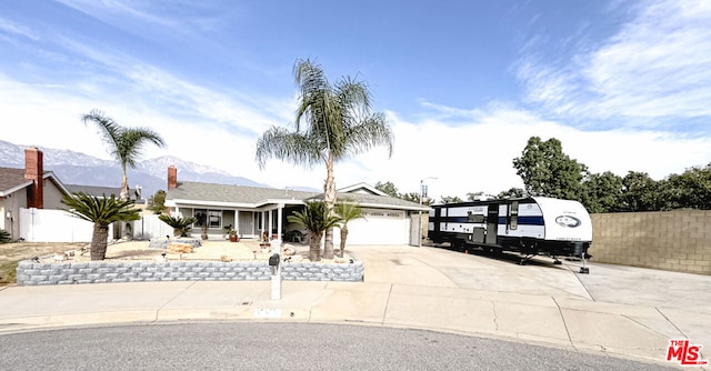 ranch-style house with a mountain view and a garage