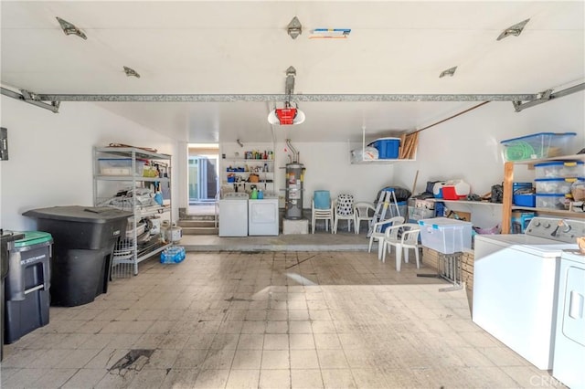 garage featuring separate washer and dryer, water heater, and a garage door opener