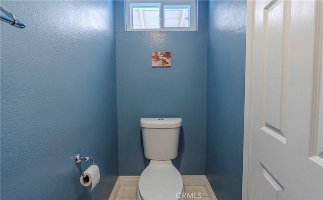 bathroom featuring tile patterned flooring and toilet