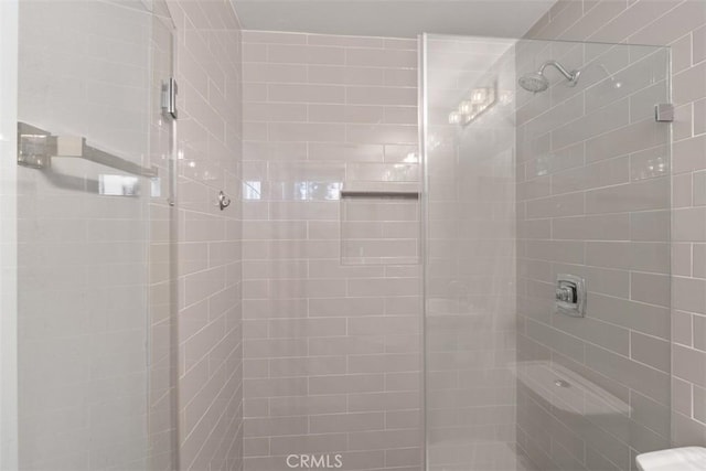 bathroom with a tile shower