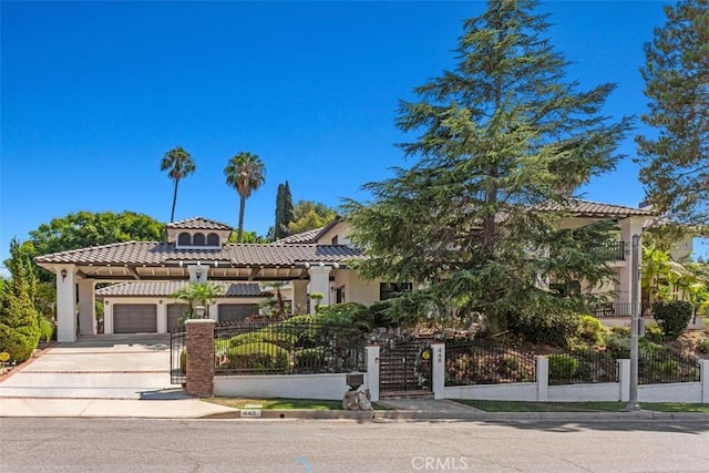 mediterranean / spanish-style home with a garage