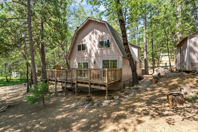 back of house with a wooden deck