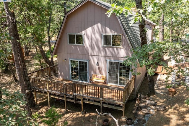 back of property with a wooden deck