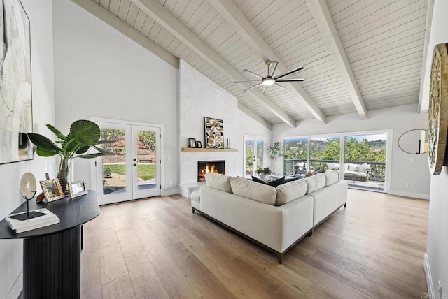 living room with high vaulted ceiling, beam ceiling, ceiling fan, and hardwood / wood-style floors