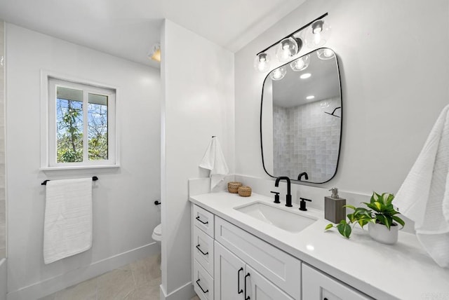 bathroom with toilet, vanity, tile patterned flooring, and walk in shower